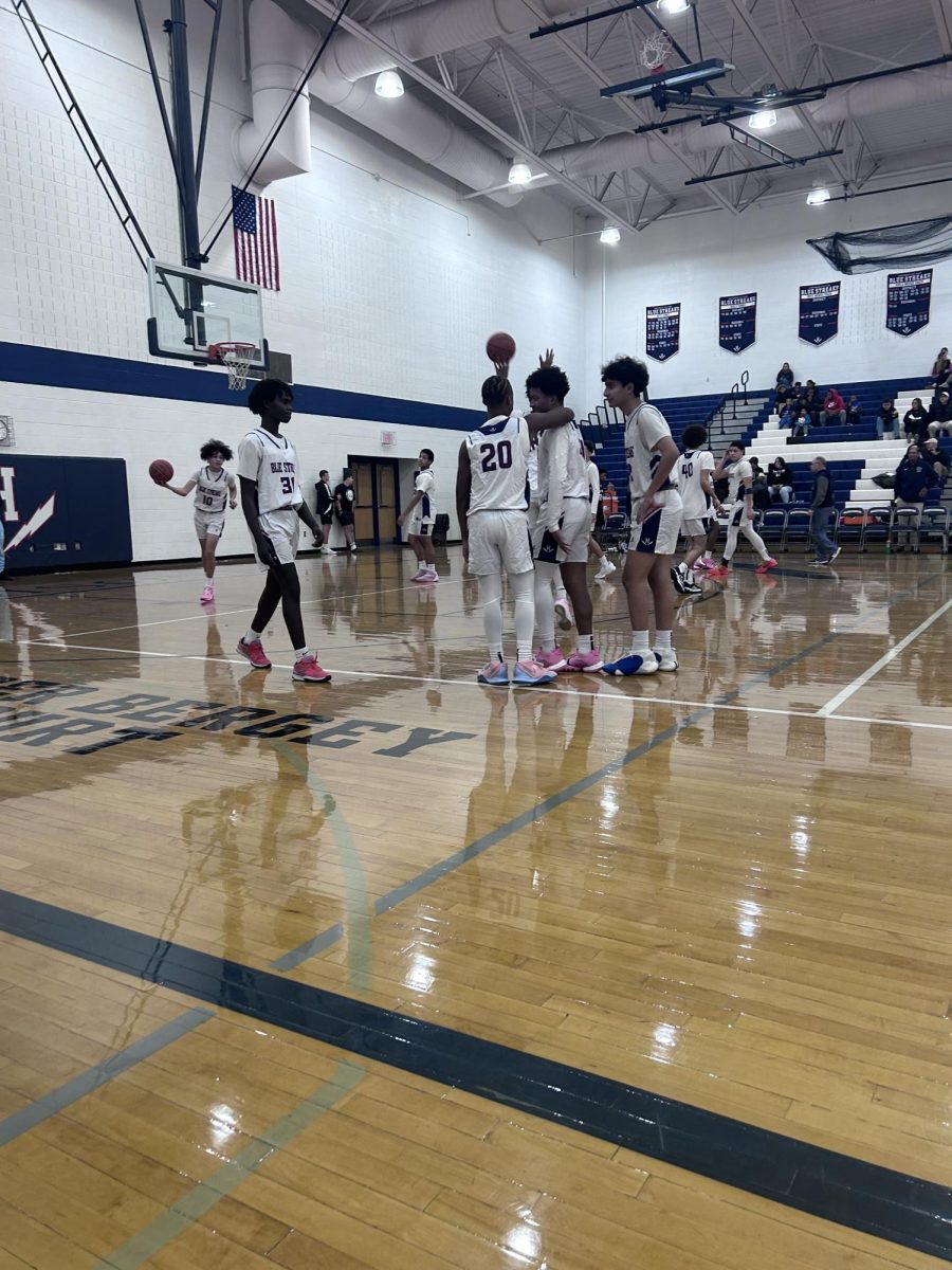 Teammates cheer each other on while warming up towards the end of halftime.