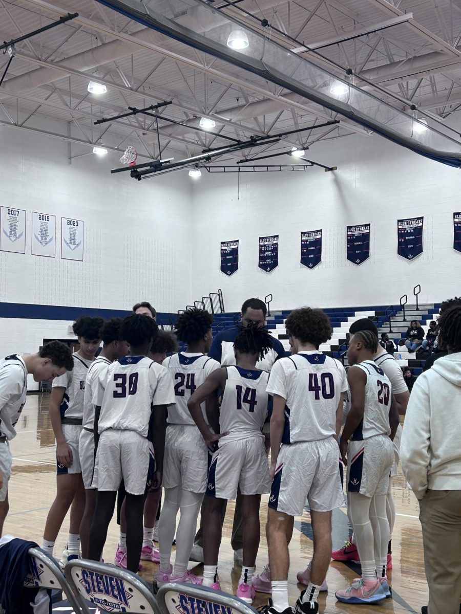 The JV team huddles during a game.