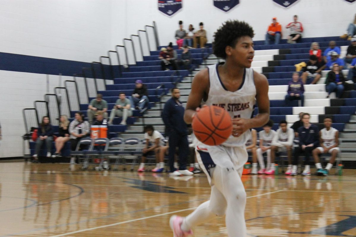 Freshman Ayden Gordon dribbles the ball down the court. 