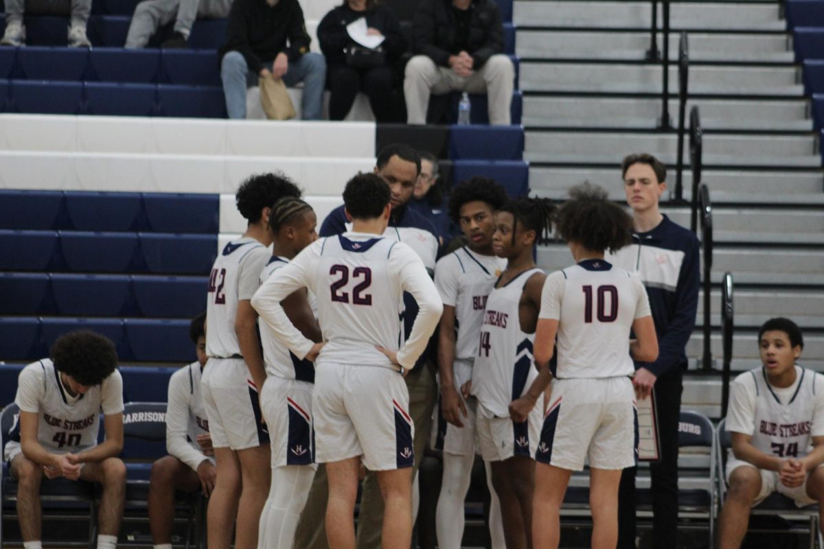 Coach Malcolm Thomas talks to a group of JV boys. 