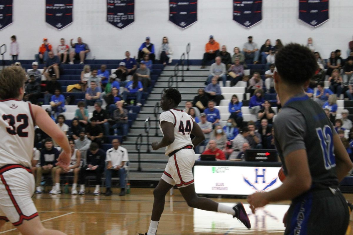 Senior Jangual Andrawas runs down the court to receive the ball. 