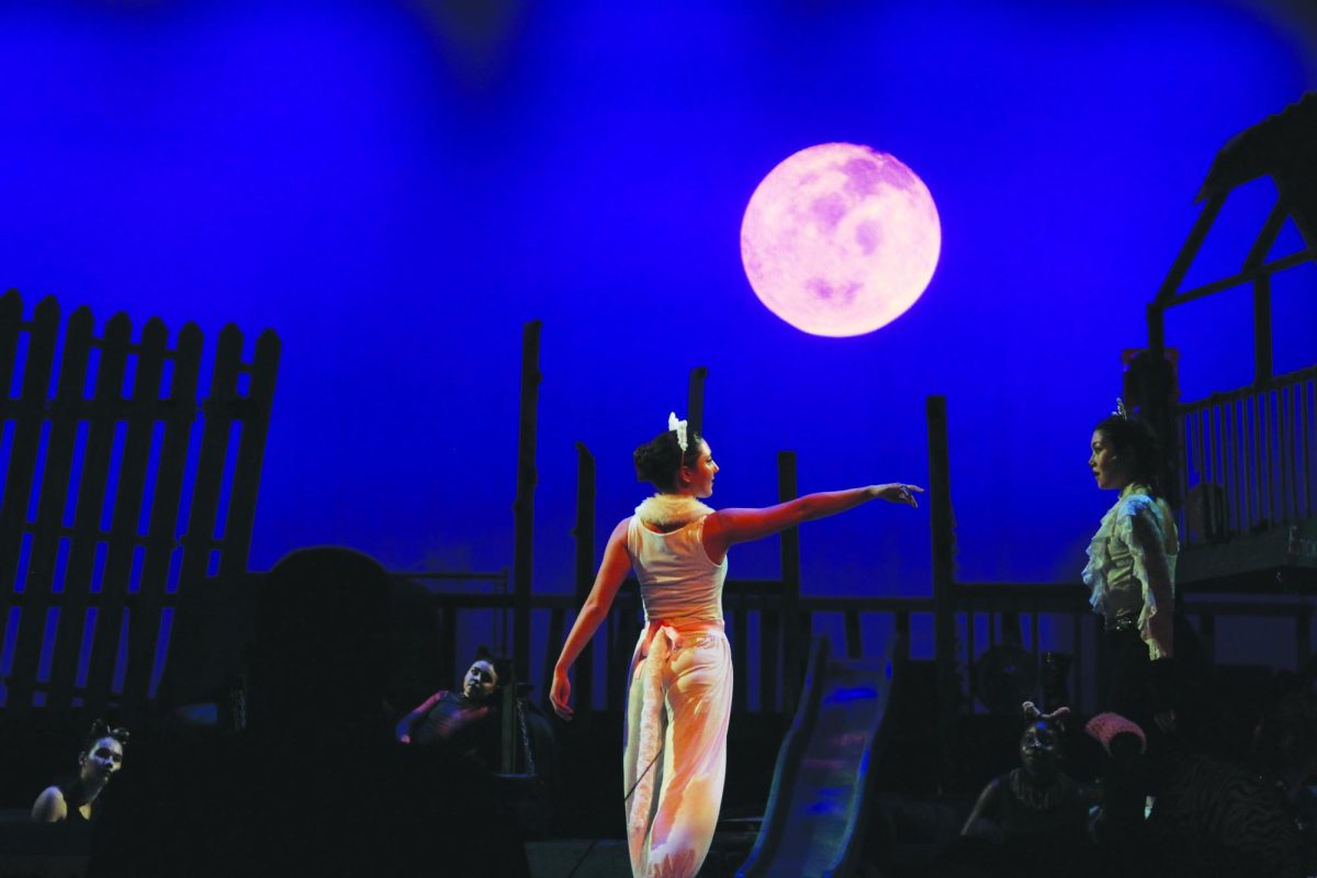 Victoria, played by junior Lydia King extends her hands to Quaxo, played by senior Jade Chao.