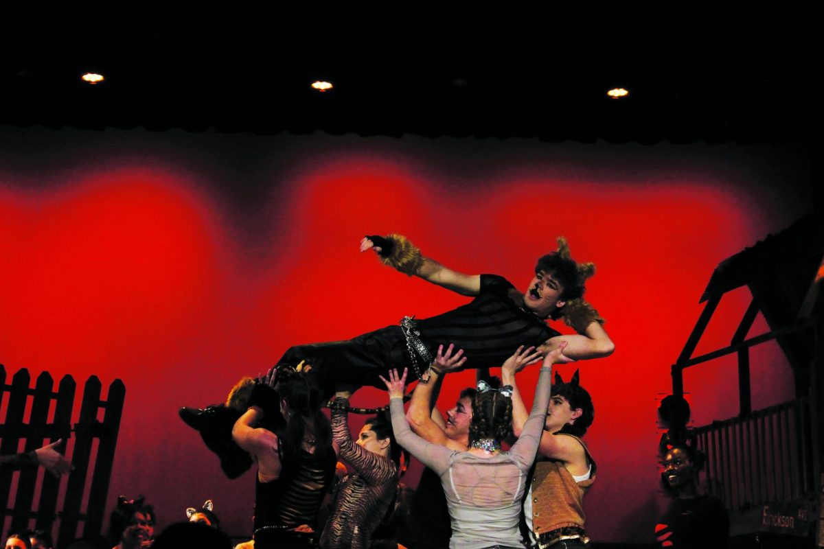 Rum Tum Tugger, played by Davis Bert, is held by other cats Skimbleshanks (sophomore Billy Perritt), Mungojerrie and Pouncival (juniors Elsie Corriston and Macy Waid), and Sillabub and part of the cats ensemble (seniors Caryanne Shaw and Abel Rodriguez).