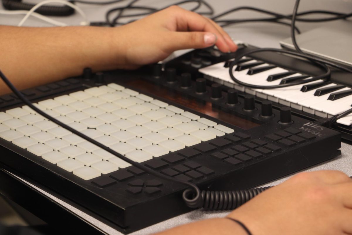 On The Road Student makes music with beat maker
