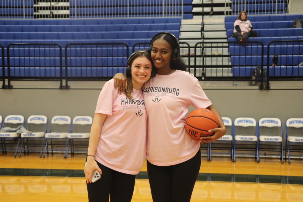 Seniors Marlin Abraham and Addison Fornadel pose in their pink out warmups. 