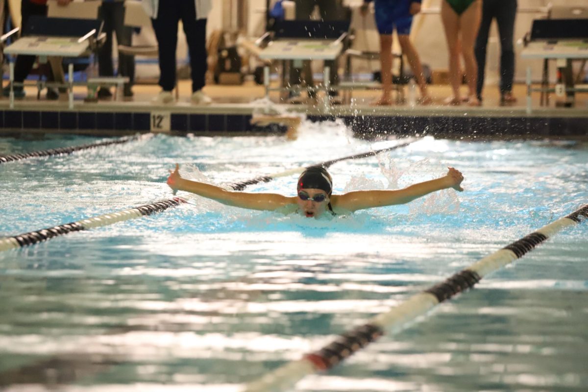 Freshman Katherine Schwartz swims butterfly stroke in race.