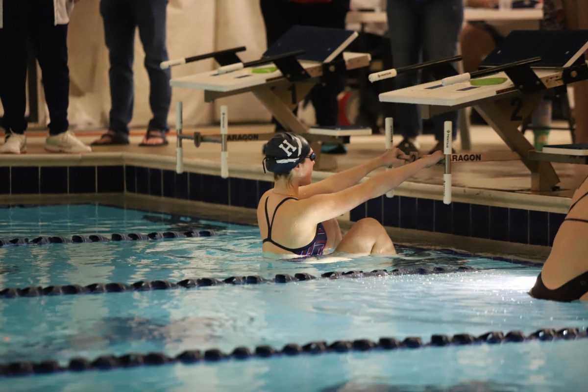 Senior Marin Sikes gets into position before swimming backstroke.