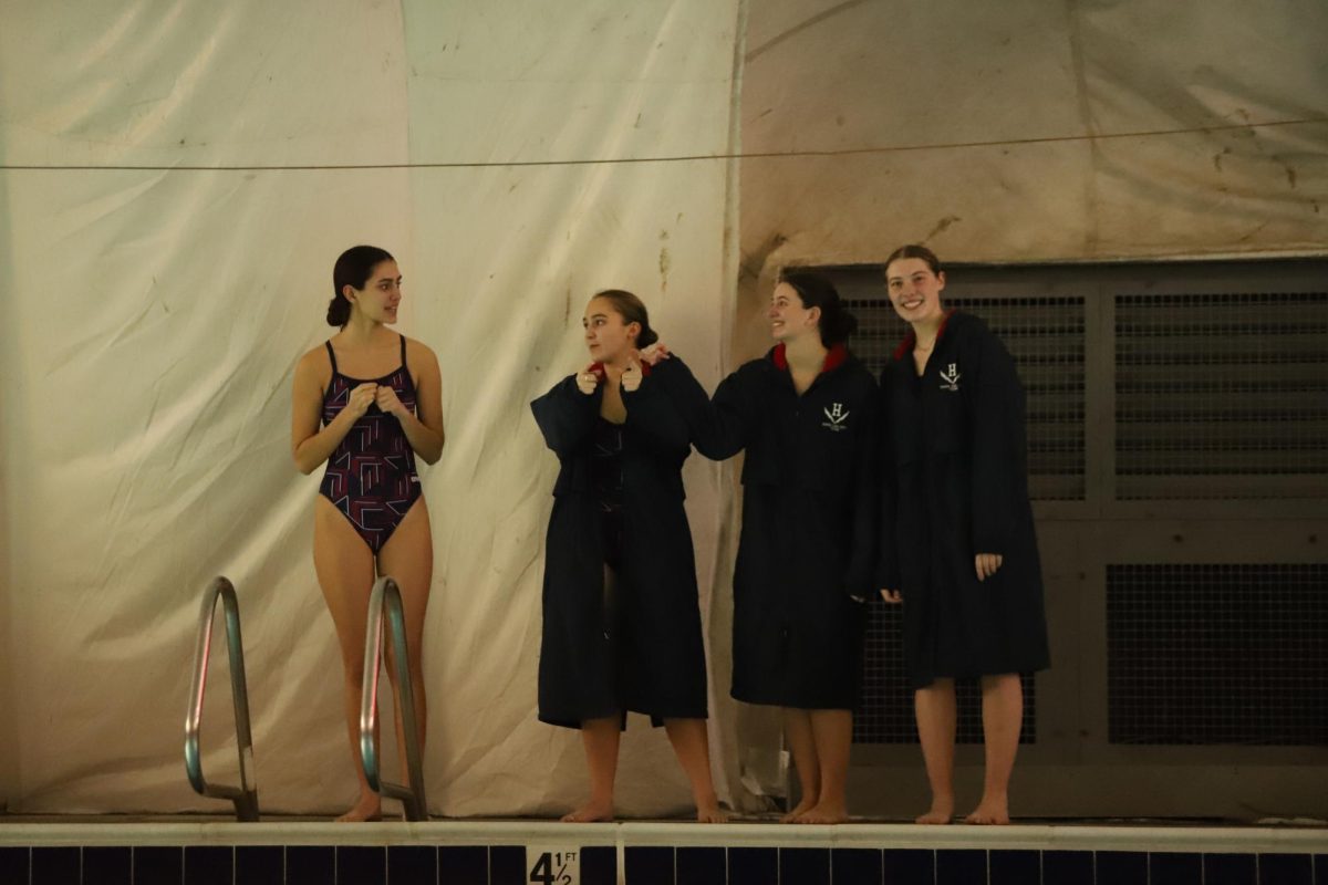 Senior girl swimmers stand after being recognized.