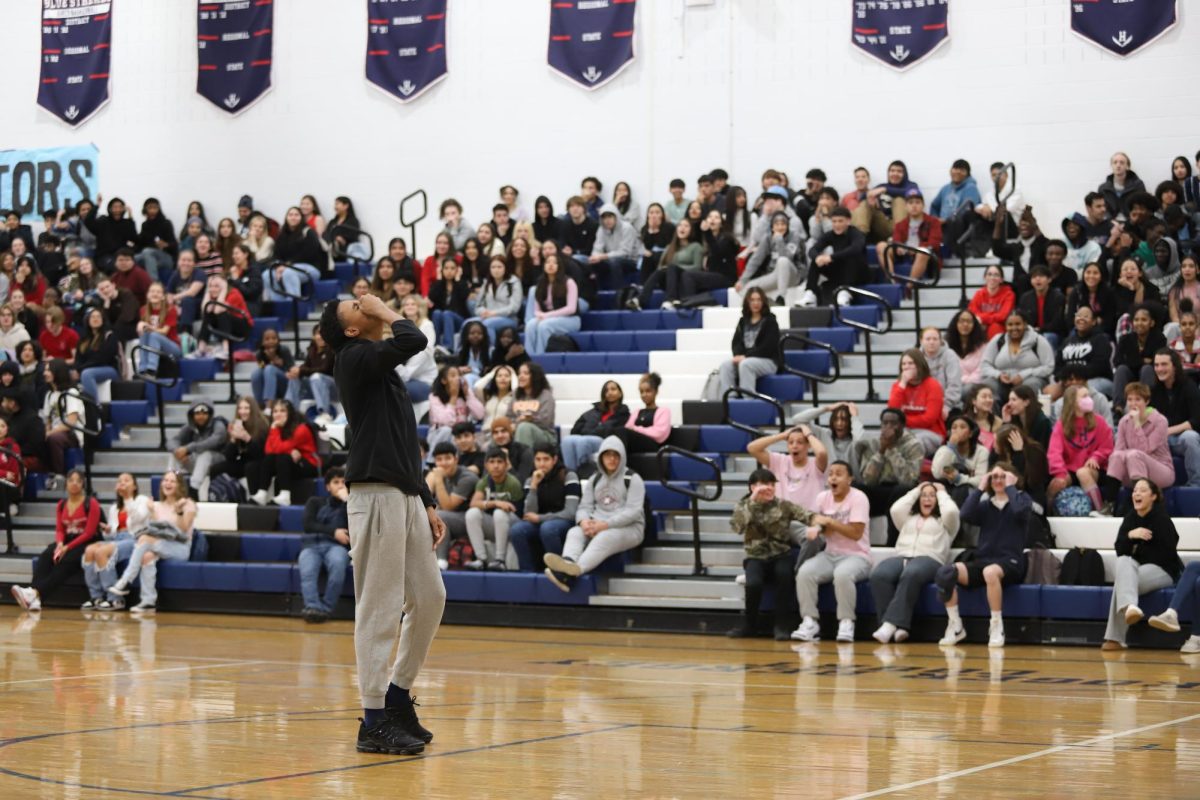 Sophomore Ahmyas Barber misses a free throw during a competition game at the winter pep rally. 