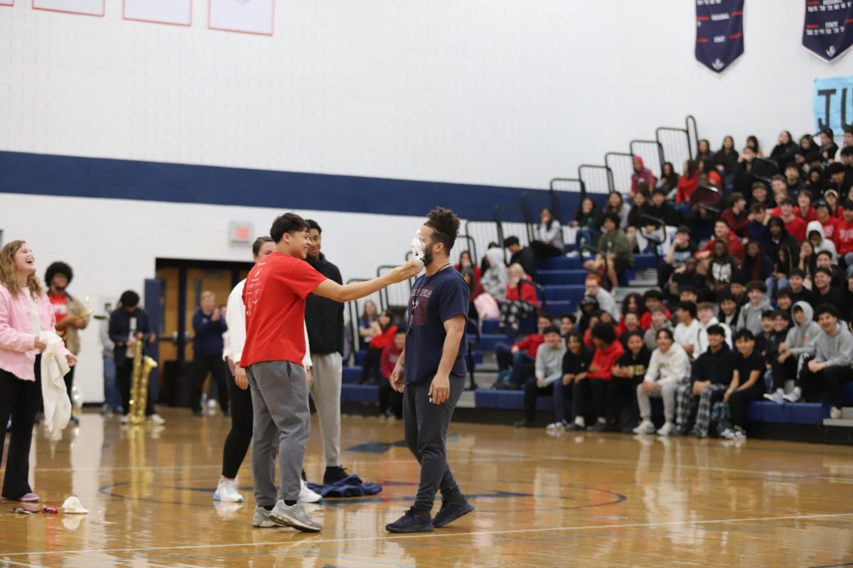 Senior Fausto Hernandez pies  teacher Curtis Cherebin 