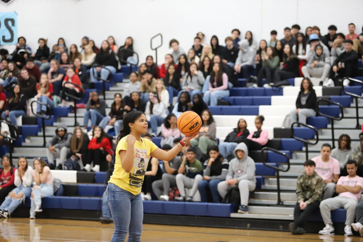 Freshman Dalwina Ciprian Nova prepares to shoot a free throw during a competition game at the winter pep rally. 