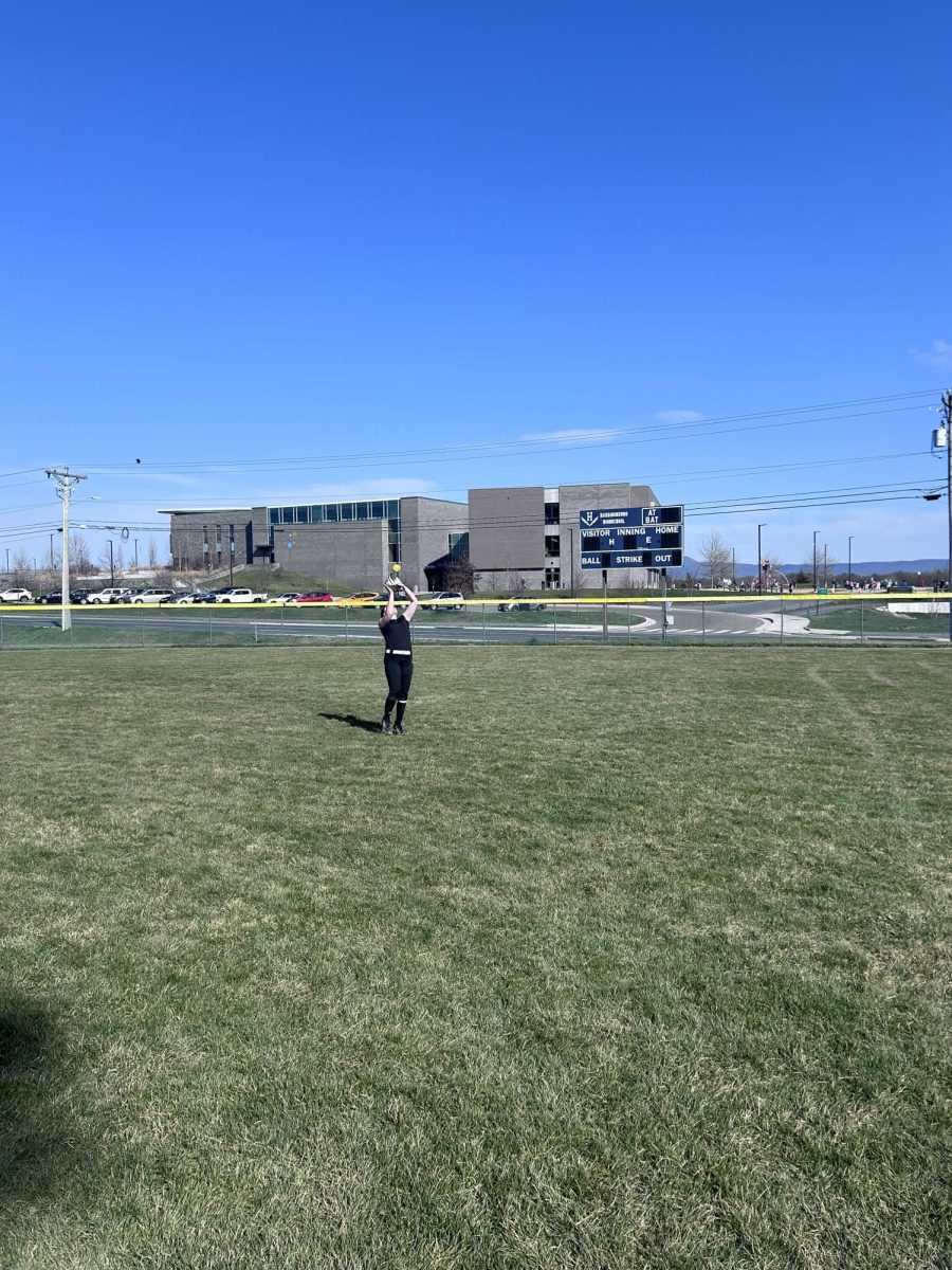 Freshman Addie Campbell catches a fly ball in the outfield.