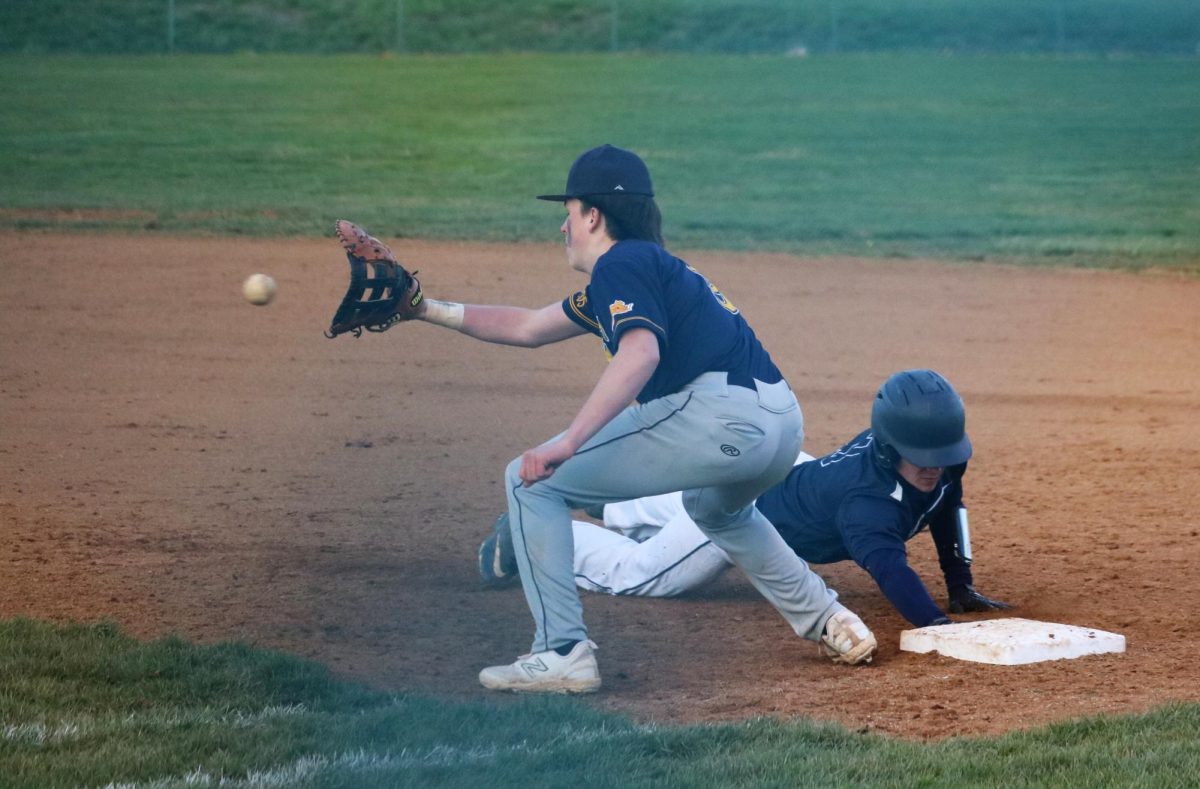 Sophomore Billy Perritt dives back into first base. 