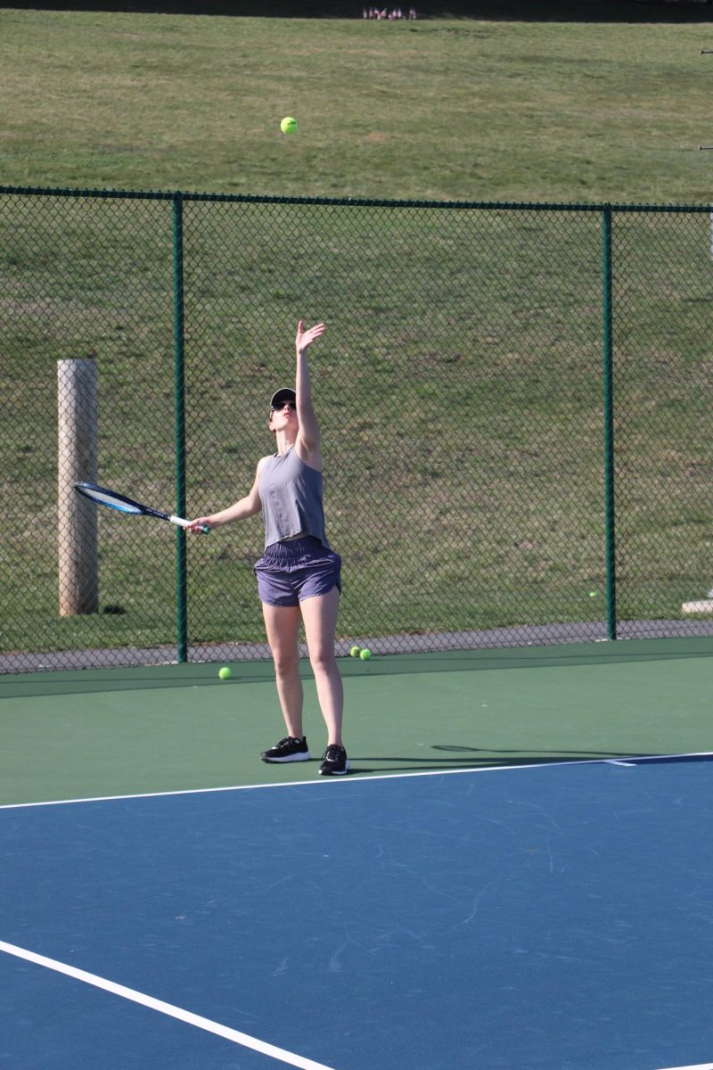 Senior Caryanne Shaw works on her serve during practice. 