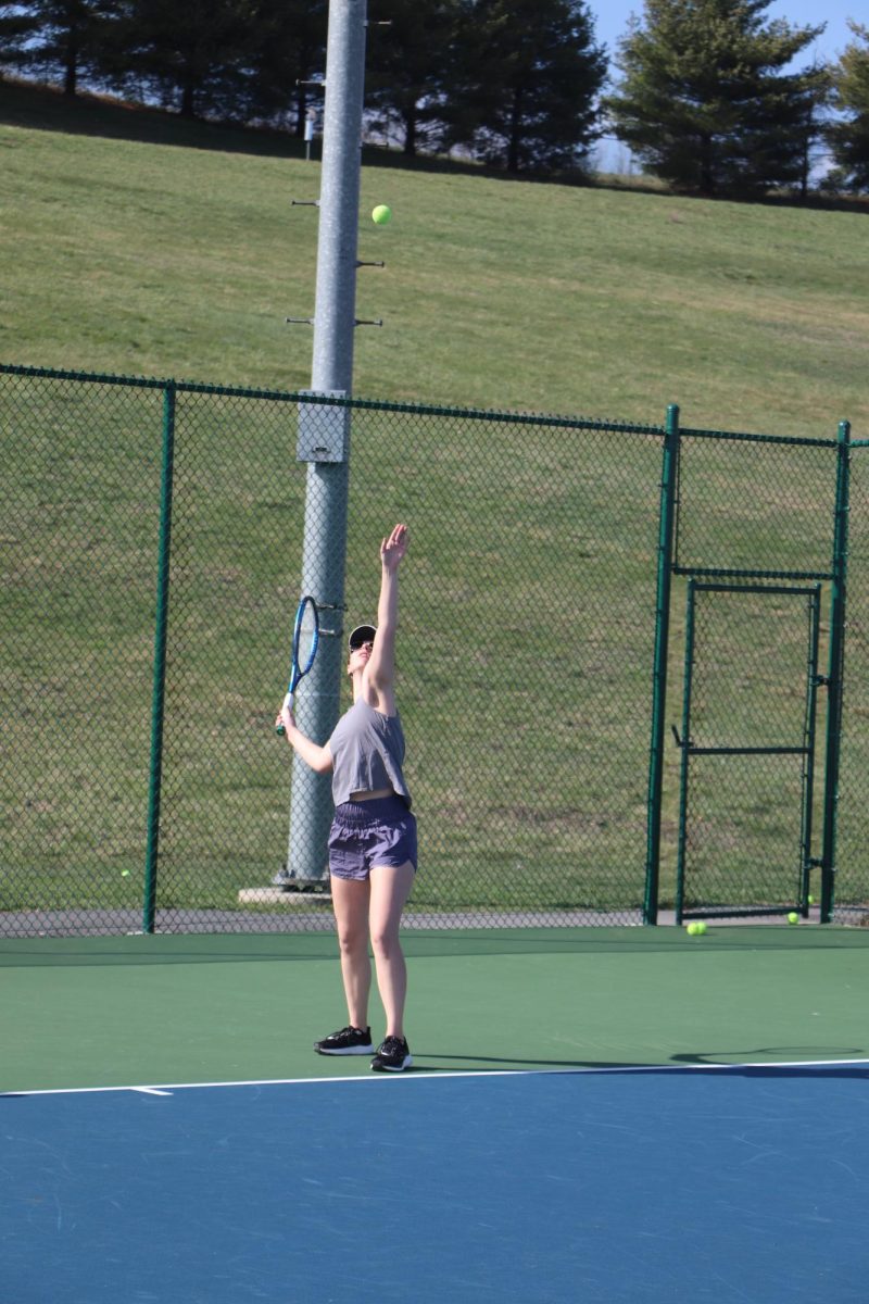 Senior Caryanne Shaw winds up for her serve during practice before their first match. 