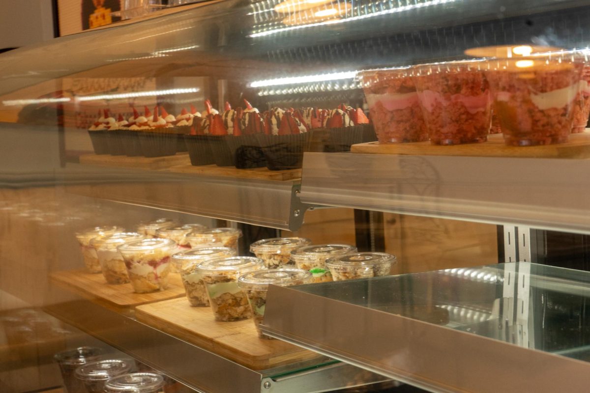 Customers are greeted by a display case with baked goods when they first enter the store. 