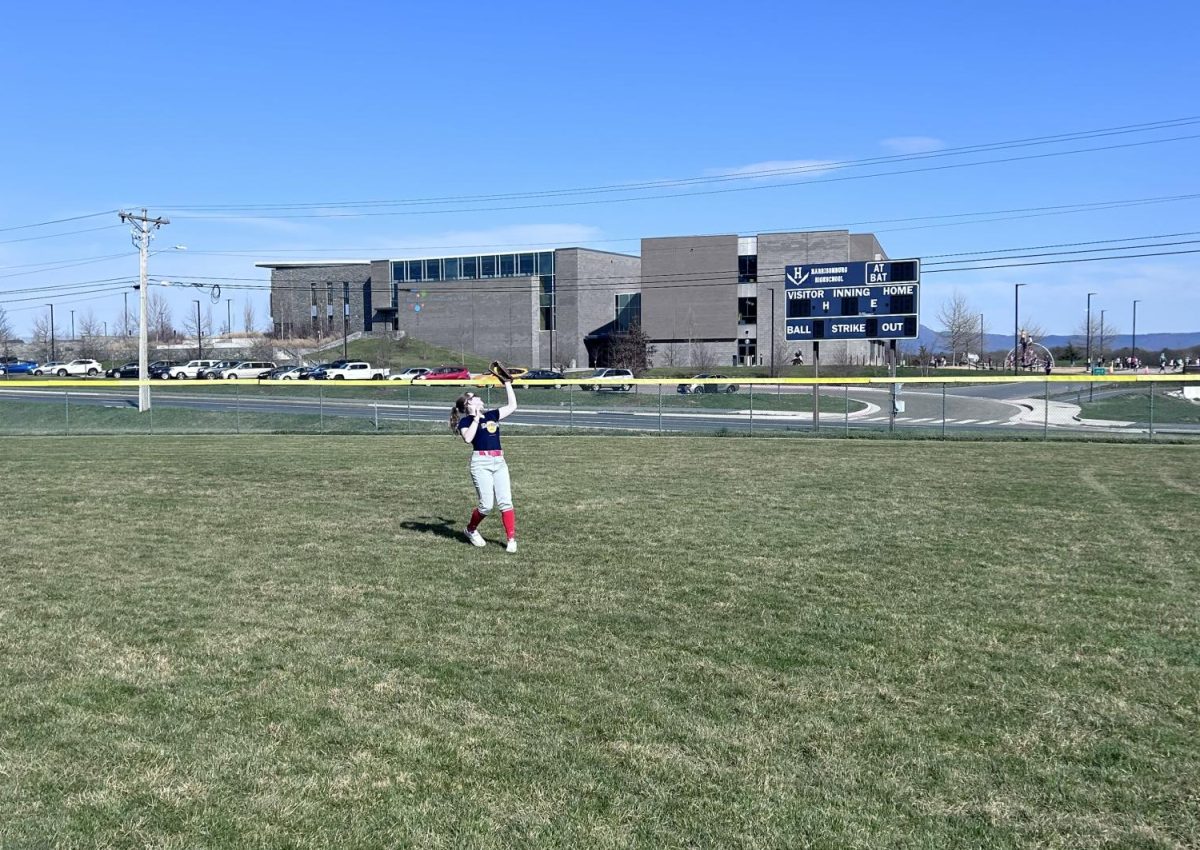 Eighth grader Helene Johnson catches a ball in the outfield.