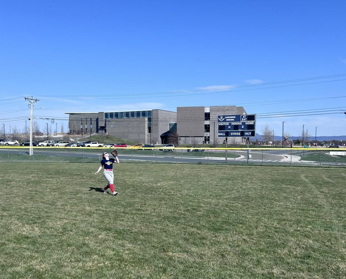 Eighth grader Helene Johnson attempts to catch a fly ball in the outfield. 