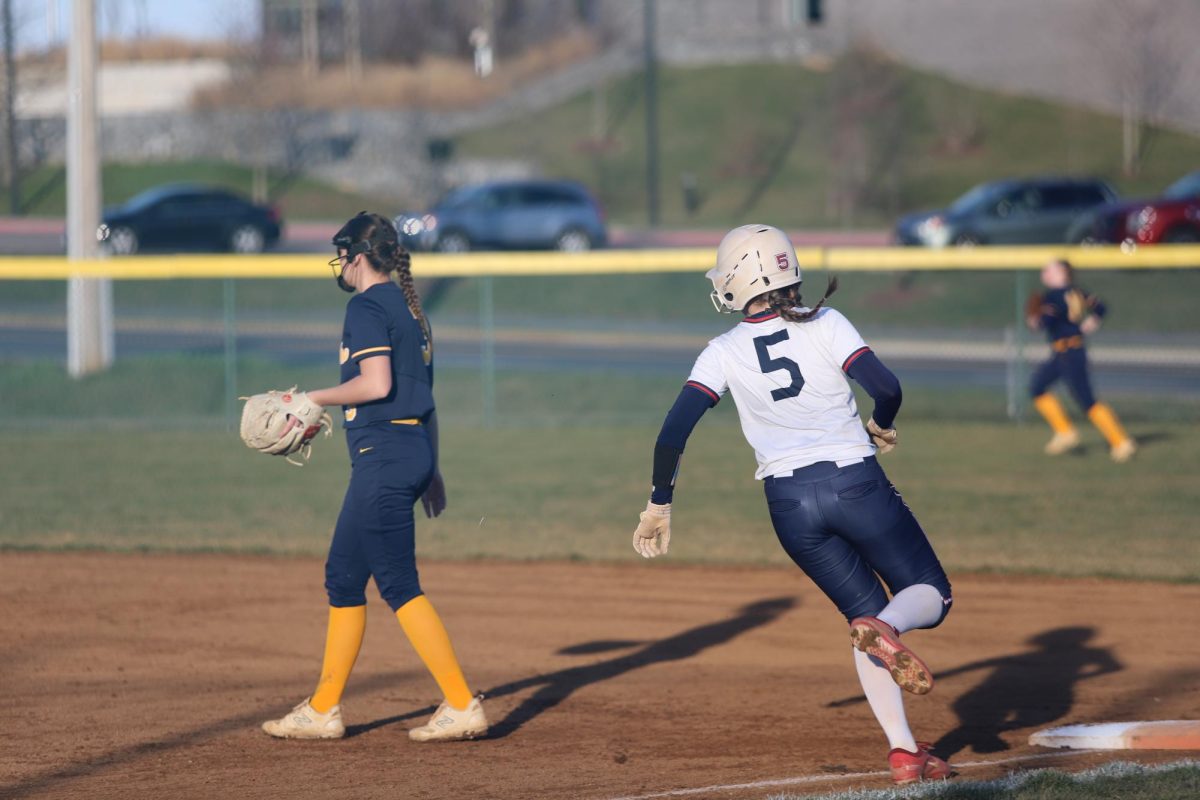 Junior Mckenna Dayton runs to first base.