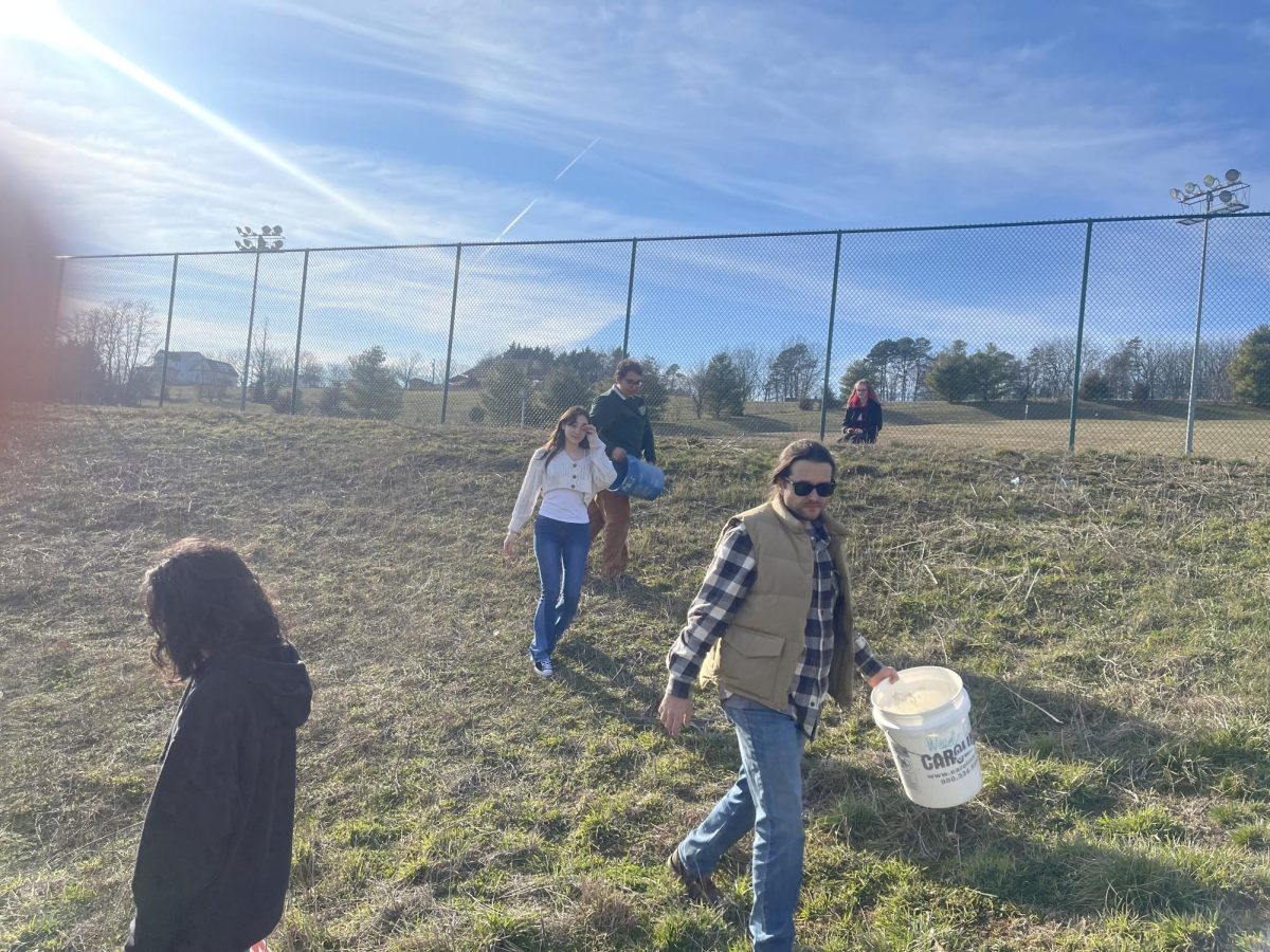 Issac Matlock collecting the empty buckets.
