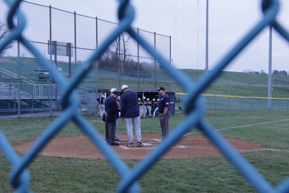 Coaches have a quick meeting before the game.