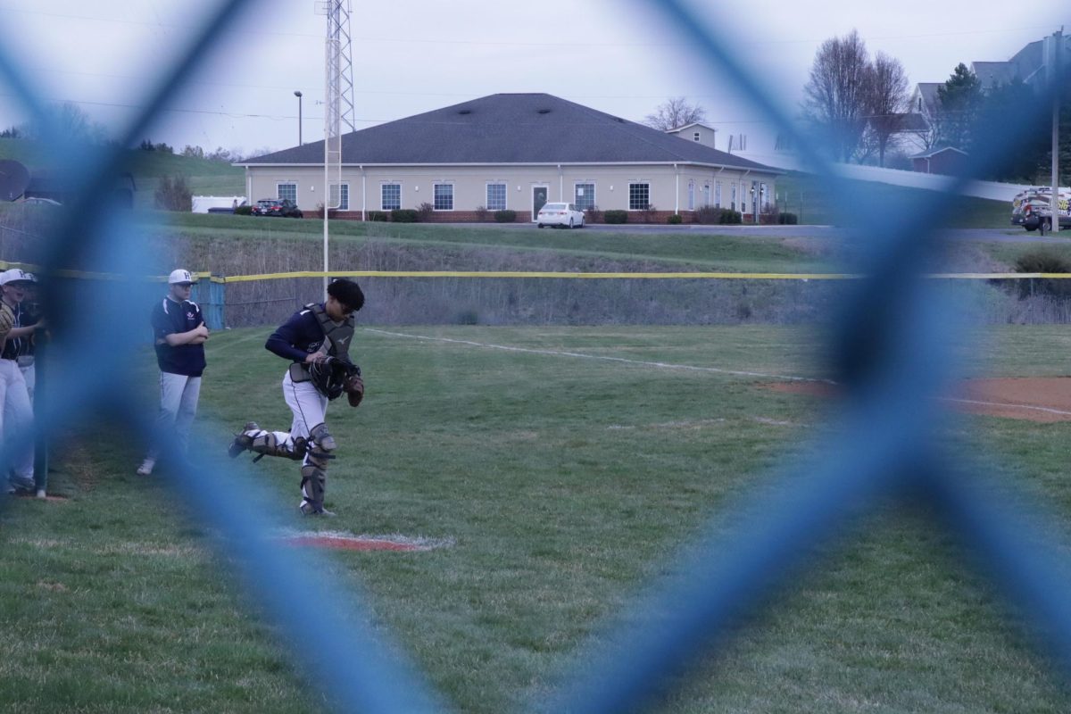 The catcher getting in position for the game.