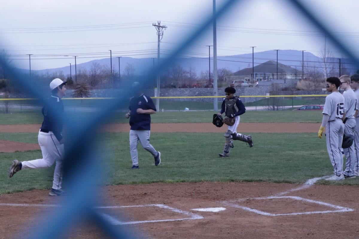 JV players jogging in order to hand shake other players from the other team.