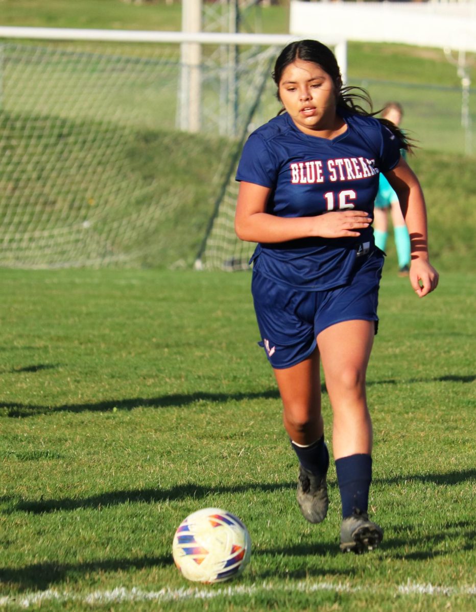 Sophomore Carmen Flores dribbles down the field. 