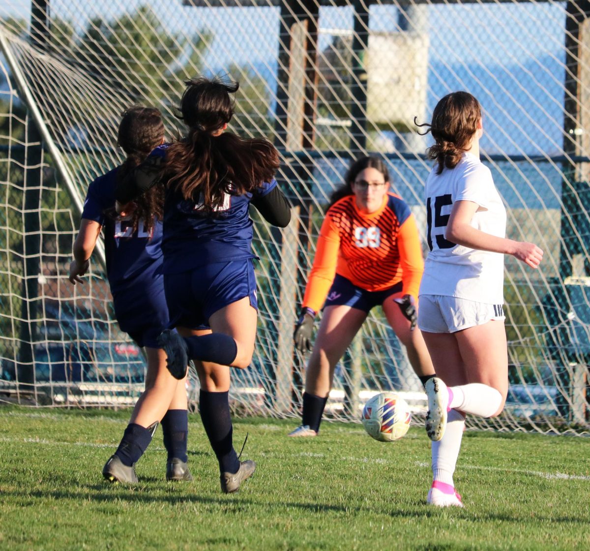 Players watch the ball as sophomore Jana Hayajneh guards the goal.