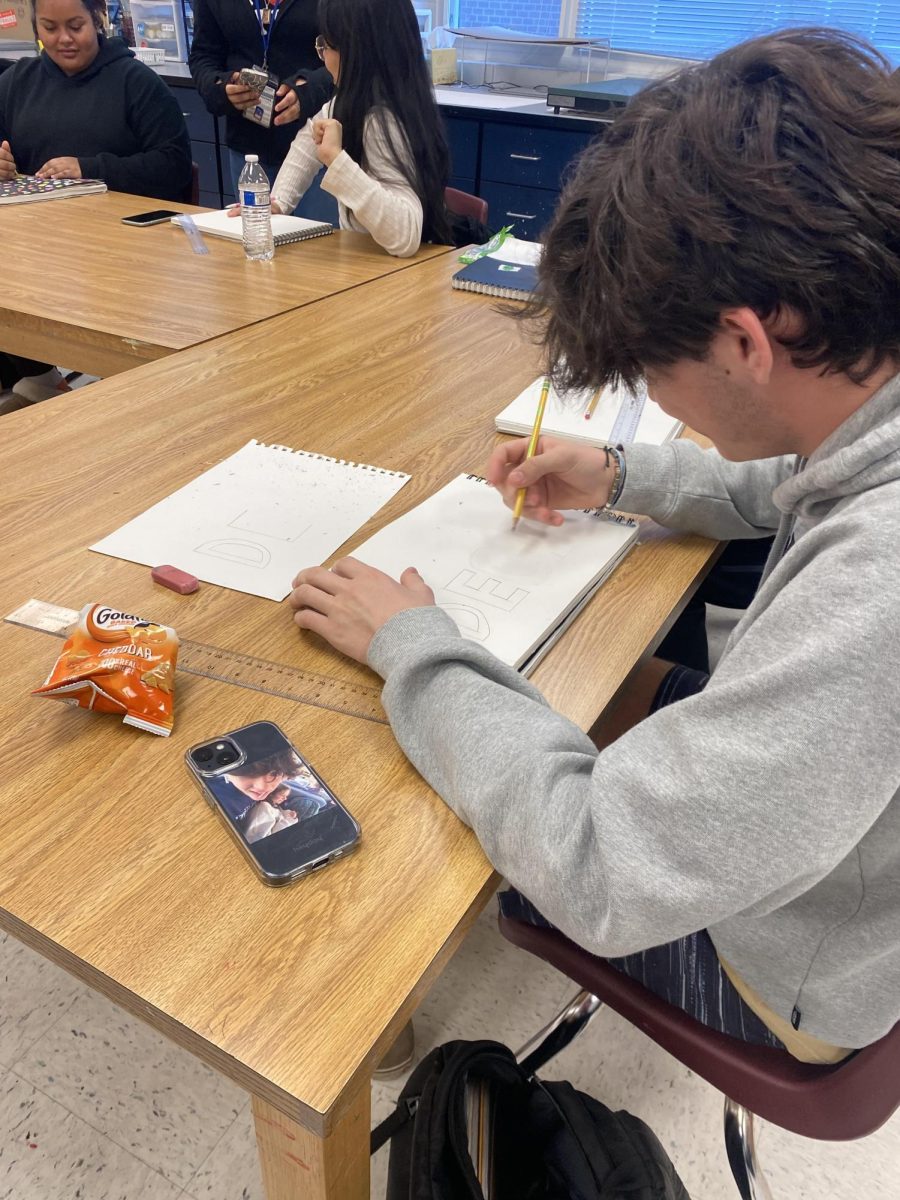 Freshman Declan Young draws out his name in block letters.
