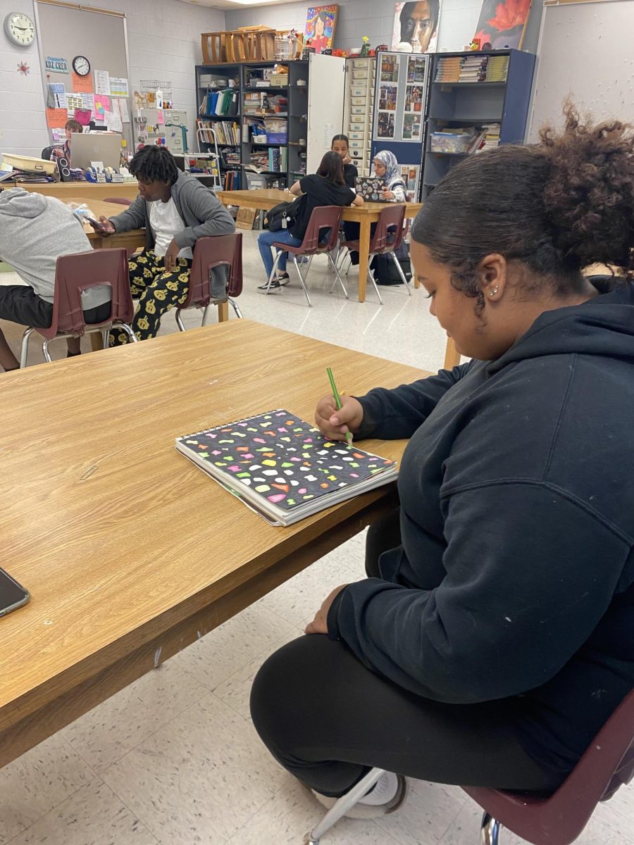Freshman Jafiyah works on her sketchbook cover
