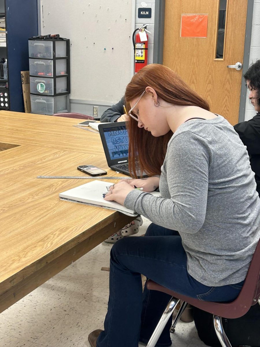Student focuses on their work for art class