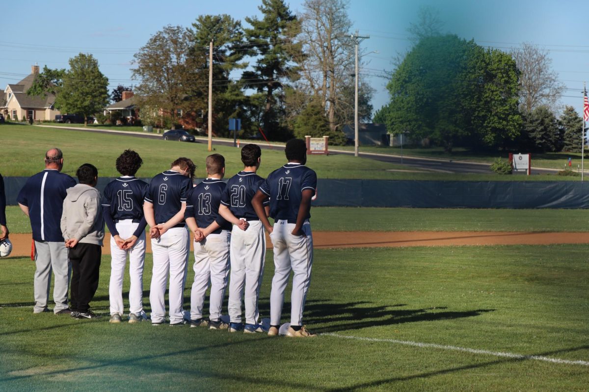 Players standing in a line for the pledge of allegiance.
