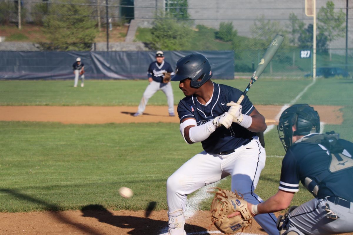 Player hitting the ball after it has been thrown.