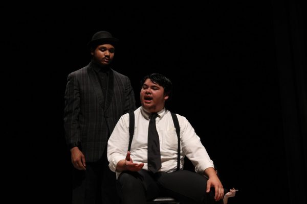 Senior Amoryan Ferguson and junior Noah Rahman engage in a discussion on stage.