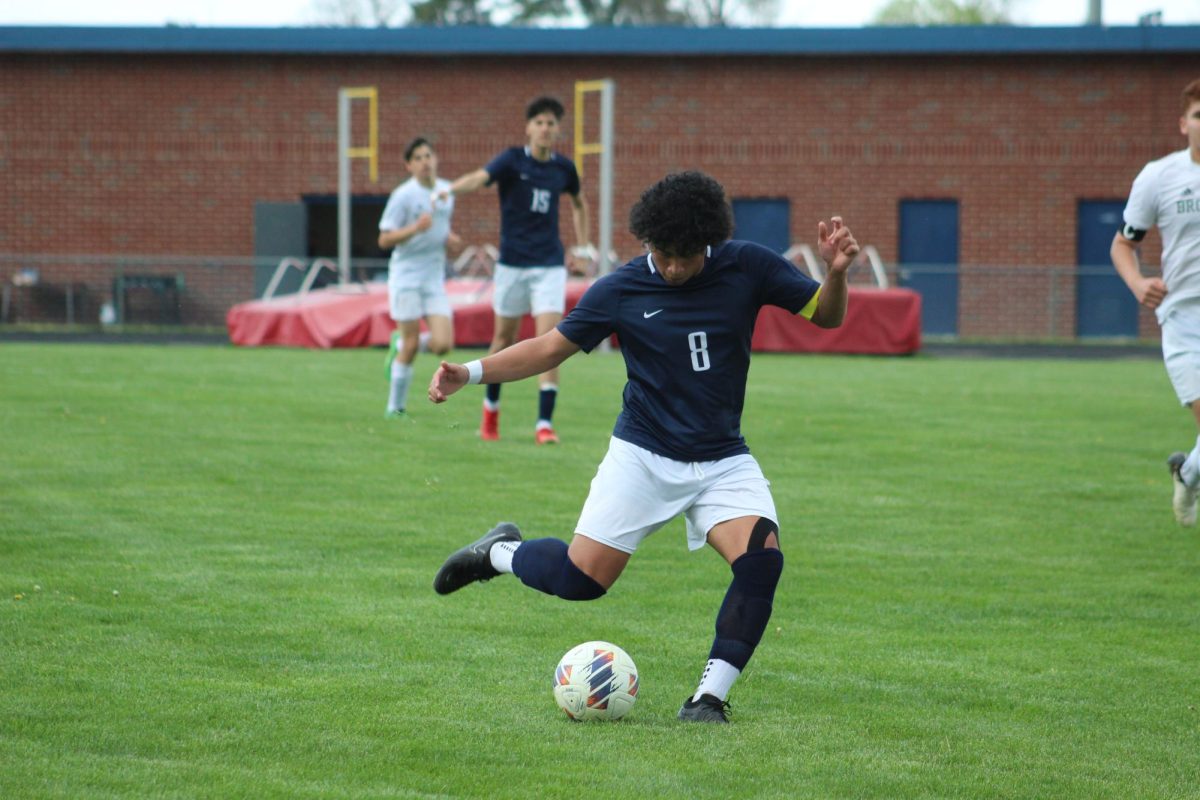 Sophomore Kaiden Velasquez hitting a long ball into the box.