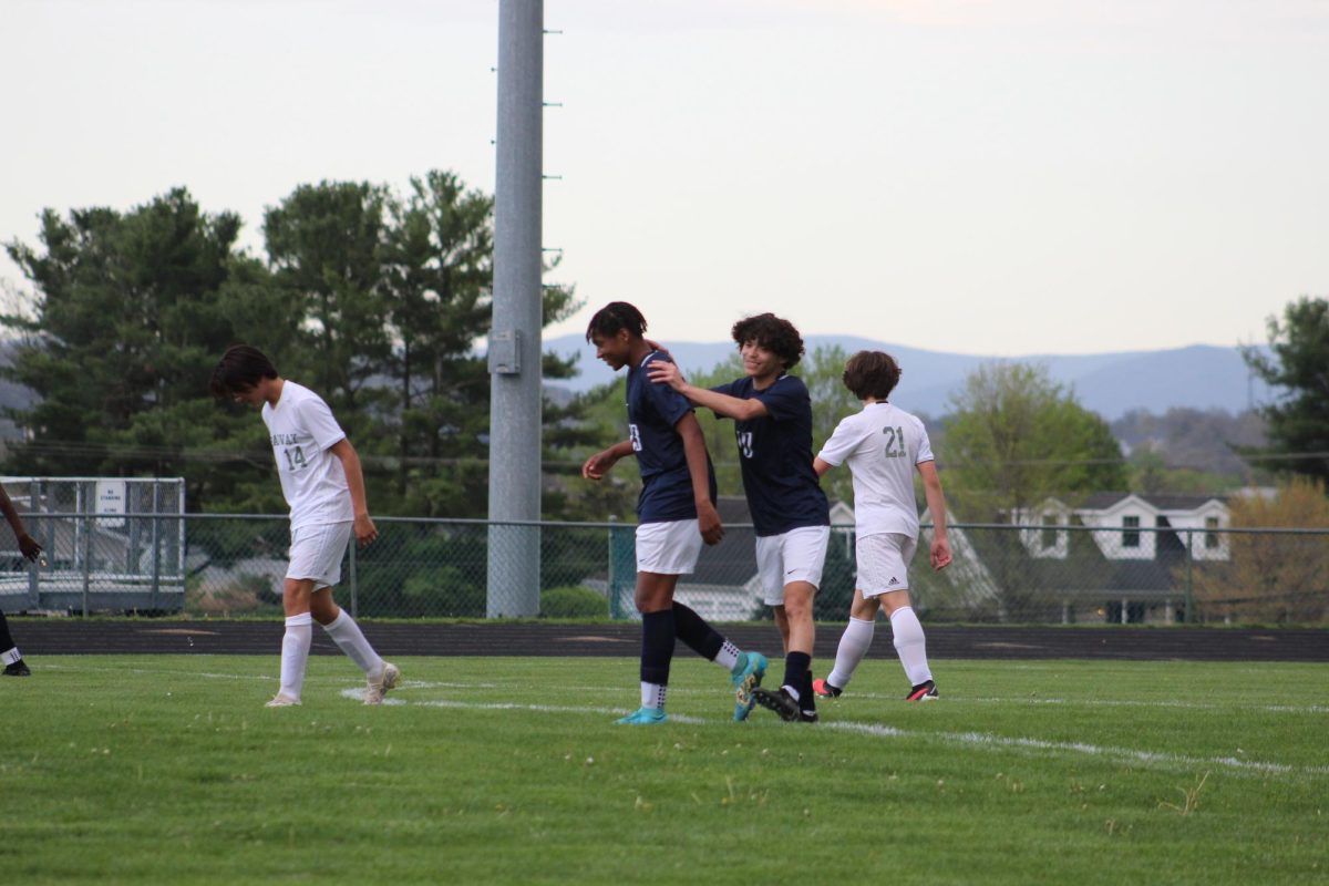 Sophomore Elias Arbaiza congratulates Freshman Xander Blue after scoring.