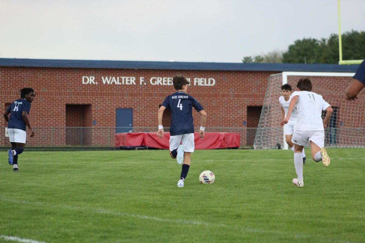 8th Grader Silas Long dribbles towards a defender. 