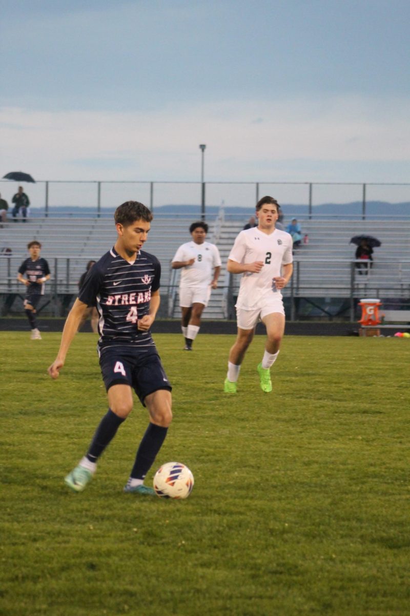Defender Sebastian Rivas making a pass forward. 