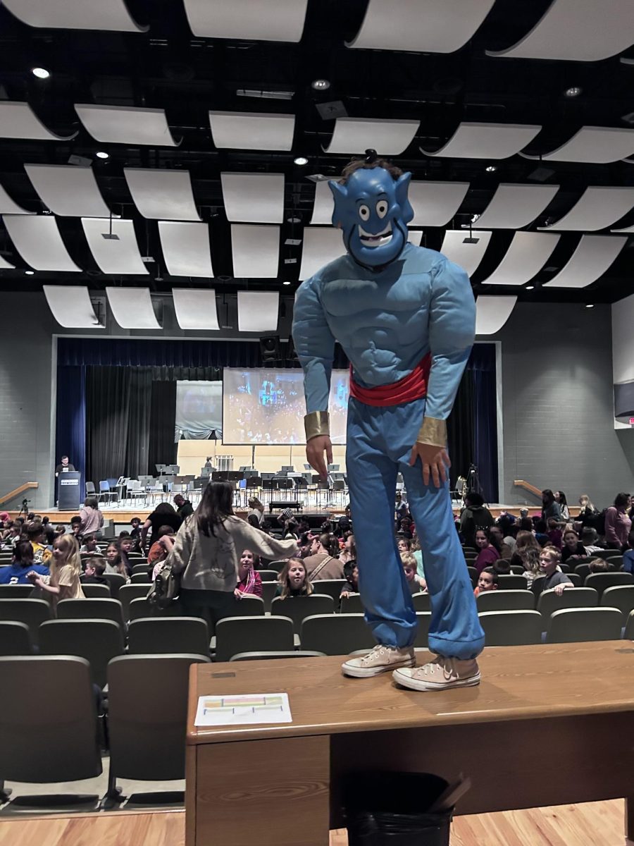 Junior Davis Bert dresses up as a Genie to wave at the children as they leave.