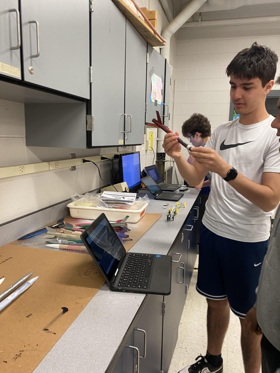 Hamza Al Khafaji explains to his classmate about his rocket project