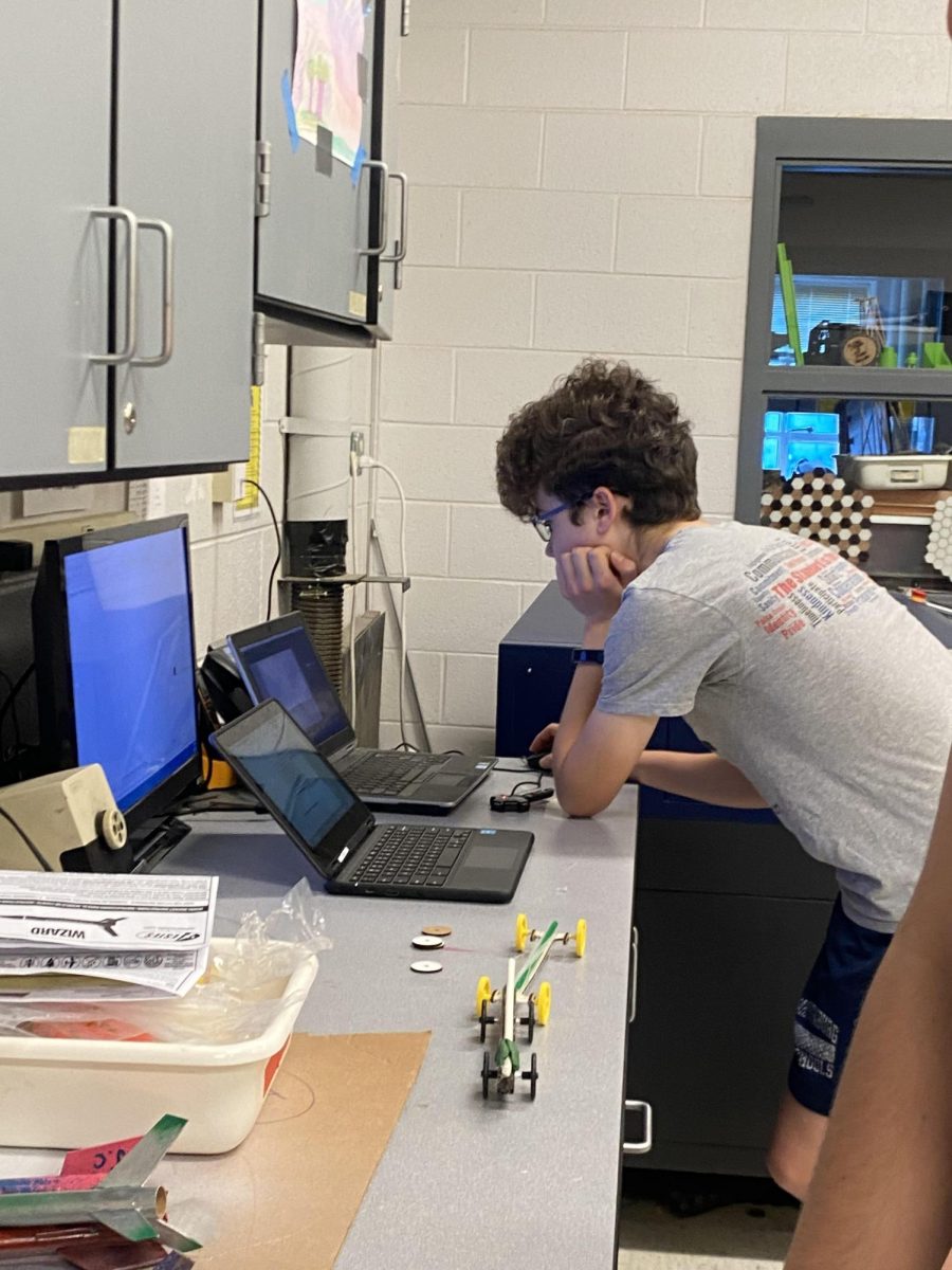 Samuel Walton works on his laser cutter project