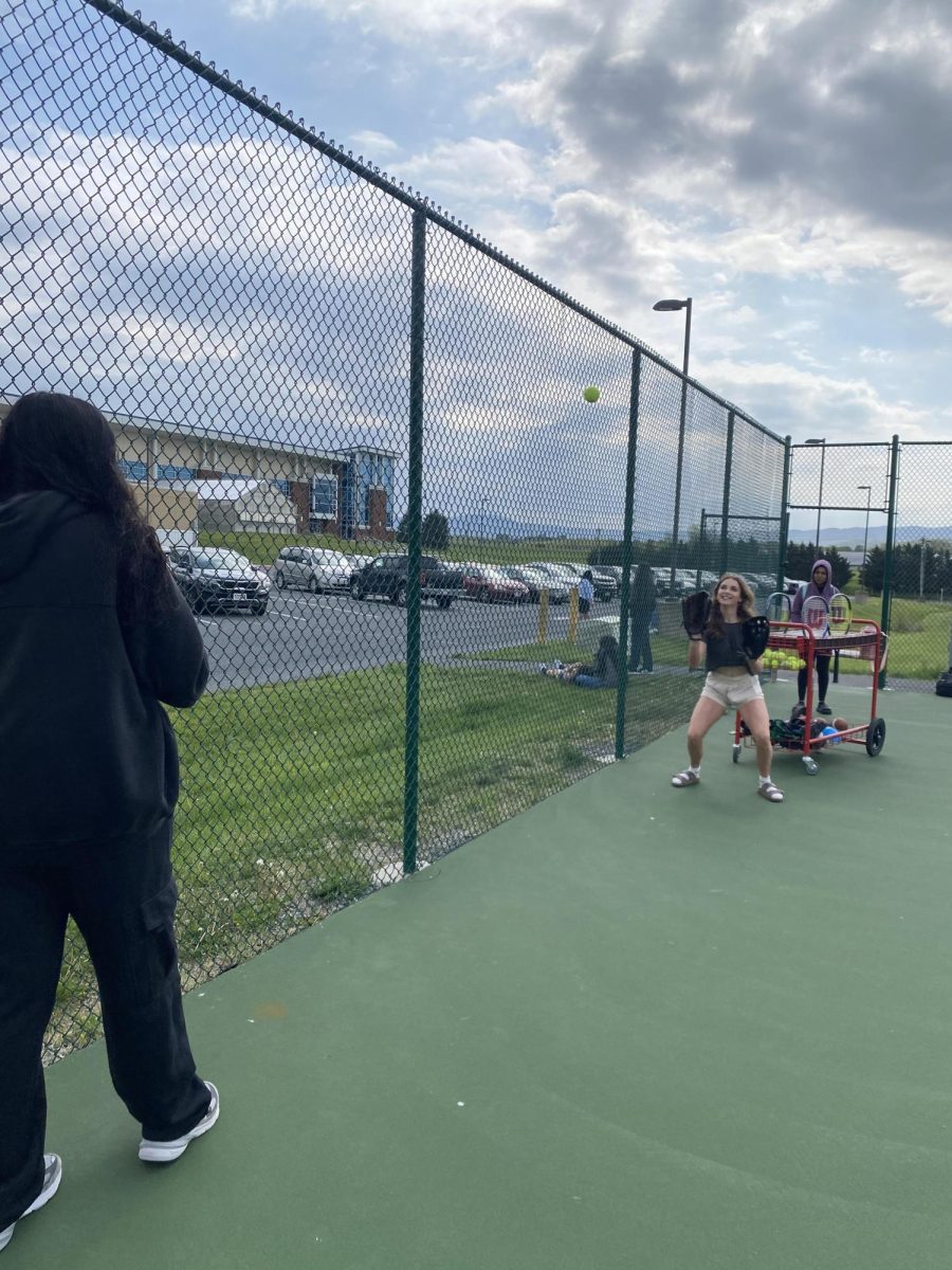 Maeve Scherpall catches a softball thrown by her friend.