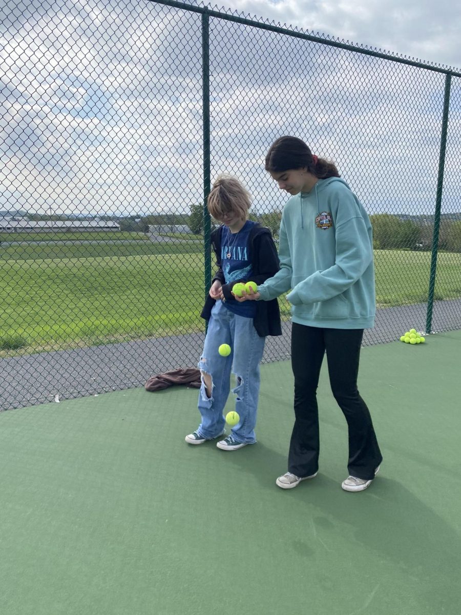 Sarah Hairston walks around tennis courts with her friend.