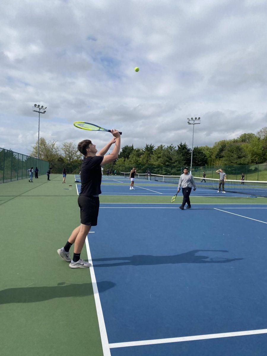 Ben Livick hits the ball to his classmates