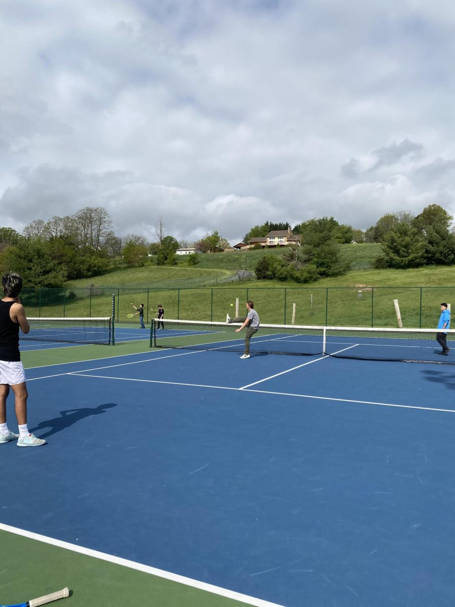 Student kicks a tennis ball in a game of tennis soccer