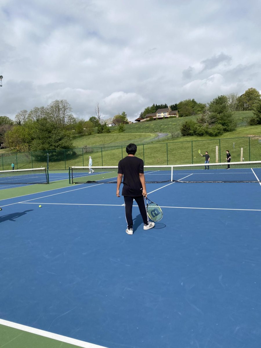 Student gets ready to hit the ball from classmate