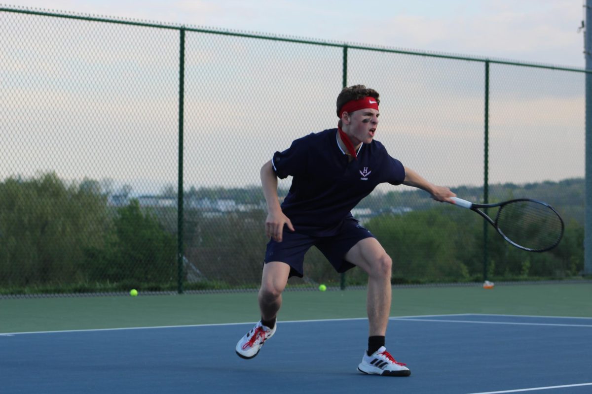 Junior Louis Gibson returns a serve to East Rock opponent.