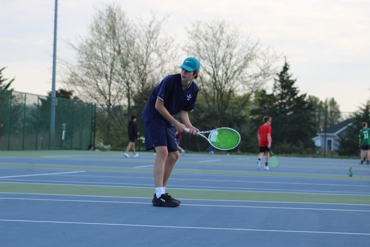 Freshman Lleyton Steins gets in ready position at the net during his doubles match. 
