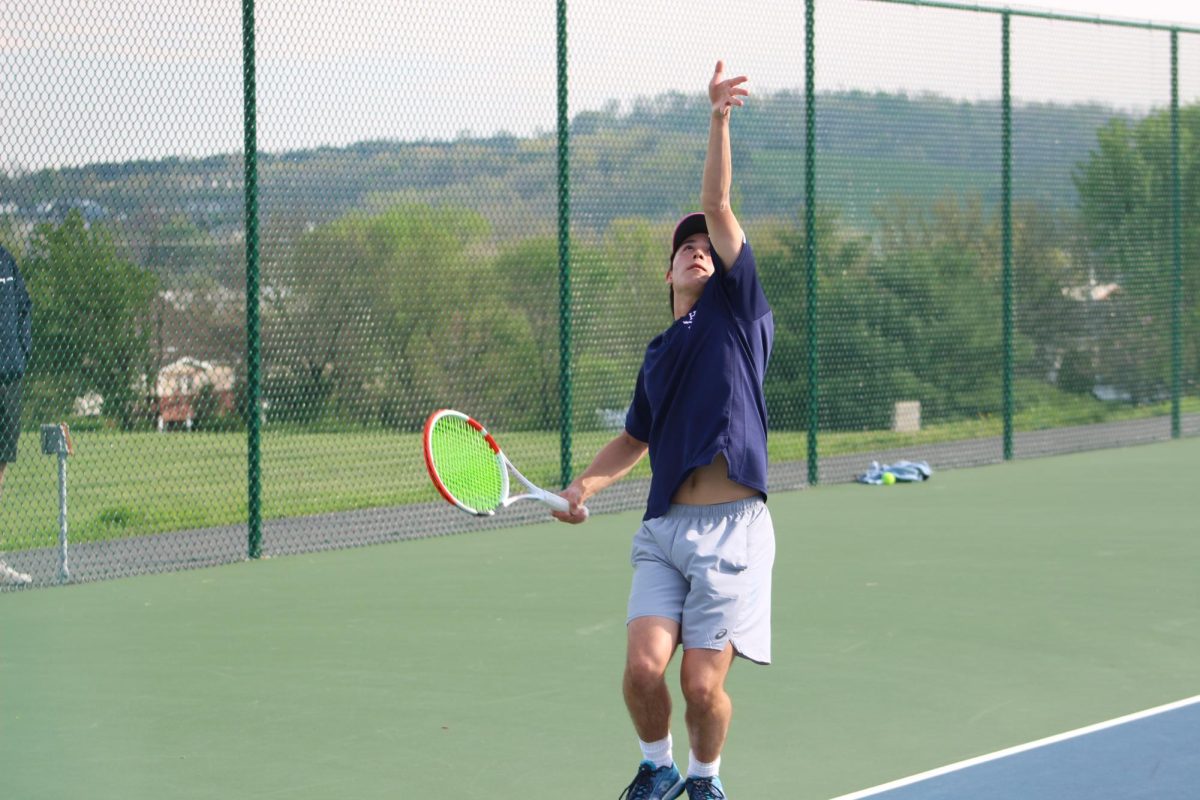 Senior Julien Steins warms up his serve. 
